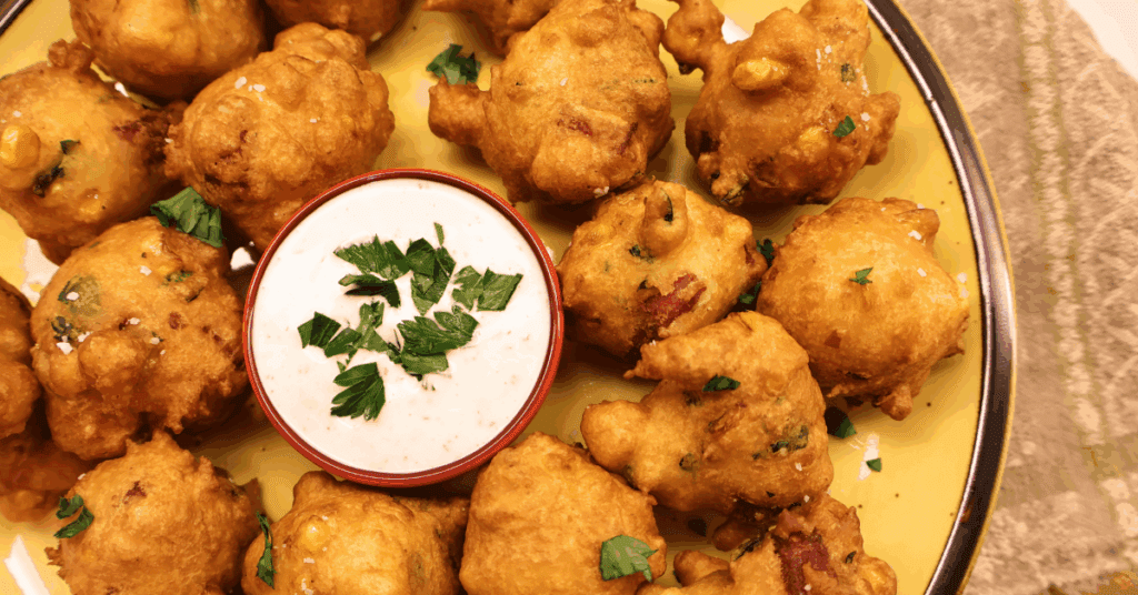 kountry boys sausage and corn fritters on a yellow plate with ranch dip