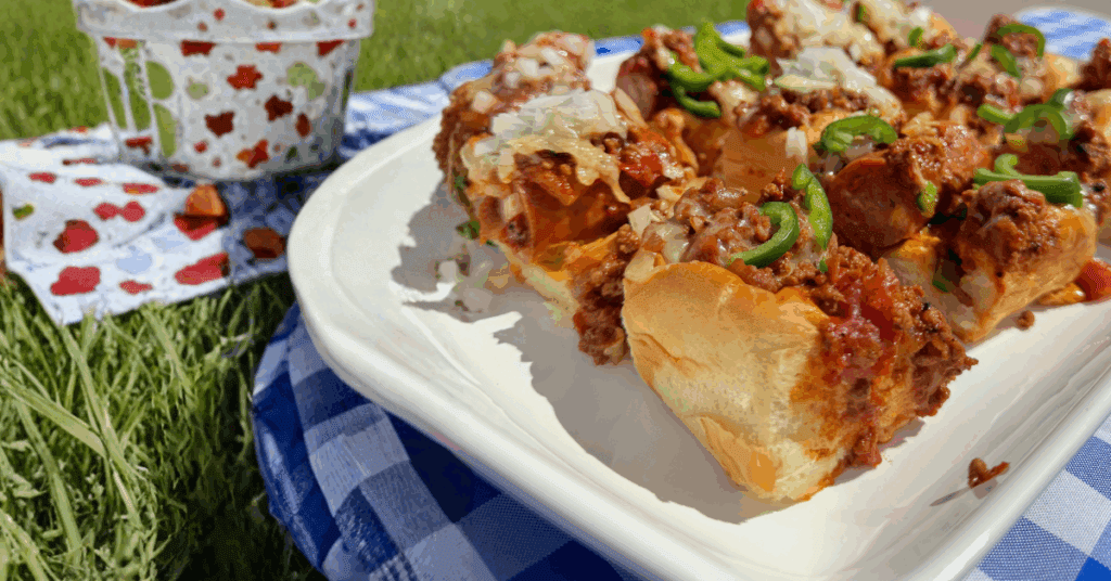 Chili cheese sliders on a plate.