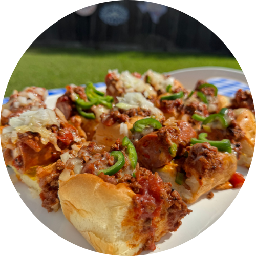 Chili dogs on a plate.