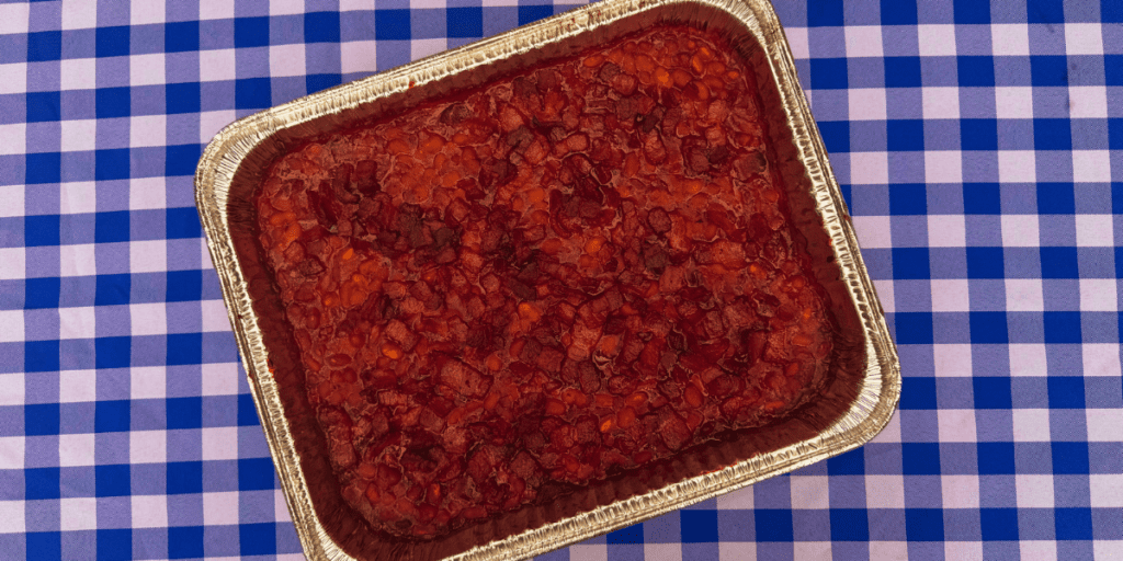bacon baked beans in a baking dish with applewood bacon